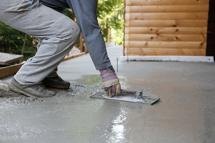 man leveling and screeding concrete